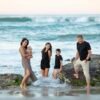 FATHER AND MOTHER PLAYING WITH KIDS OM SEA SITE