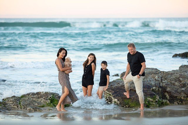 FATHER AND MOTHER PLAYING WITH KIDS OM SEA SITE