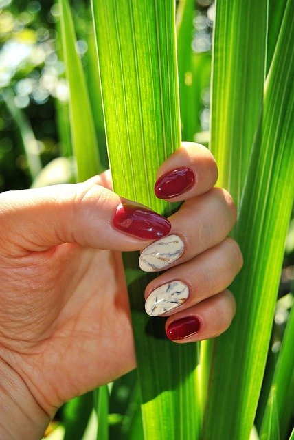 A WOMAN SHOWING HER BEAUTIFUL NAIL DESIGN