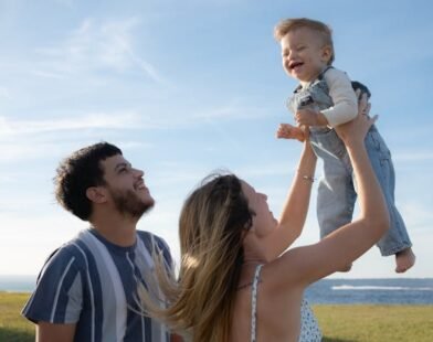 PARENTS PLAYING WITH THEIR KID