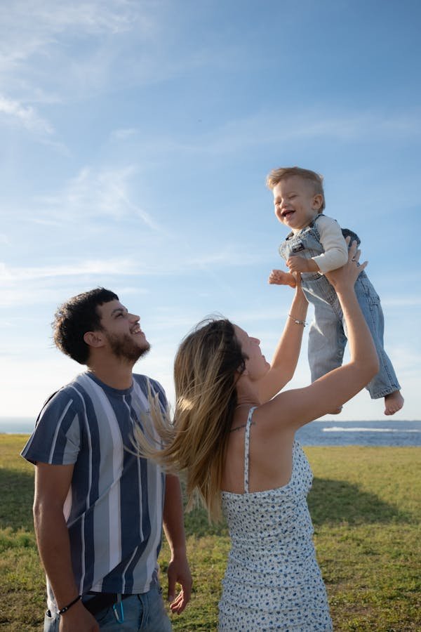 PARENTS PLAYING WITH THEIR KID