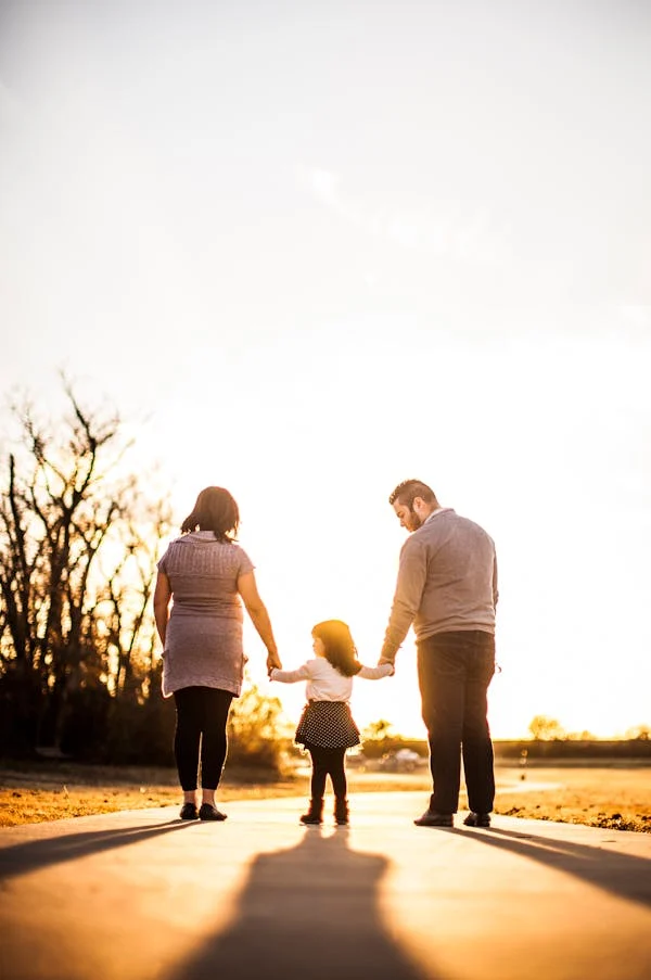 PARENTS HAVING A WALK WITH THEIR CHILD TO SHOW HIM EMPATHY