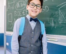 A CHILD GIVING A LECTURE IN CLASS CONFIDENTLY