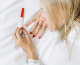 A WOMWAN CHECKING PREGNANCY STRIP