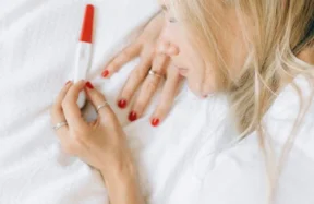 A WOMWAN CHECKING PREGNANCY STRIP