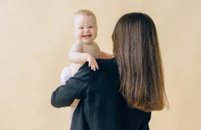 A WOMAN HOLDING HER NEW BORN BABY