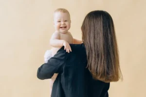 A WOMAN HOLDING HER NEW BORN BABY