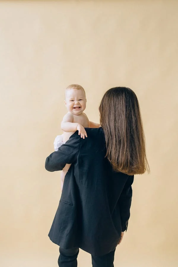 A WOMAN HOLDING HER NEW BORN BABY