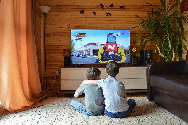 Two kids watching tv
