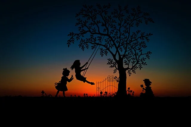 TWO CHILDREN PLAYING WITH SWINGS