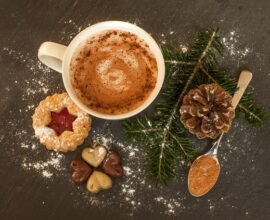 A cup of hot chocolate decorated with biscuits.