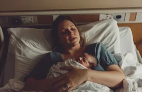 A mother in the hospital after giving birth to a baby.