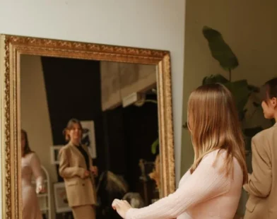 A WOMAN LOOKING AT A PAINTING AFTER JUST INSTALLING AT HOME