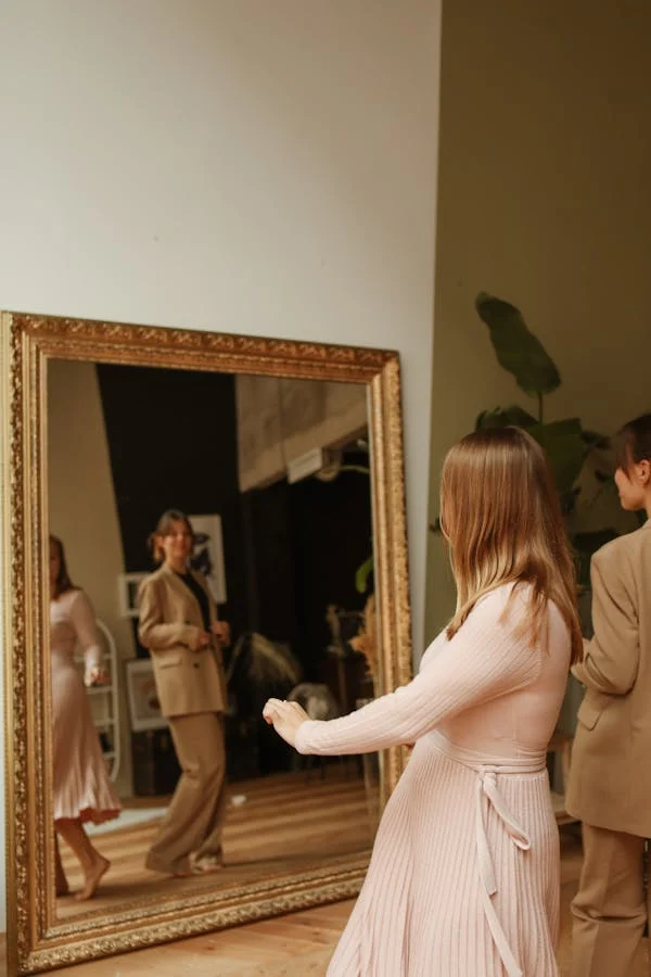 A WOMAN LOOKING AT A PAINTING AFTER JUST INSTALLING AT HOME