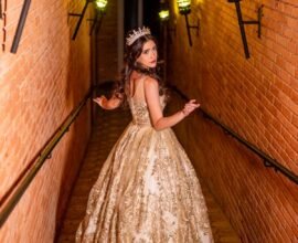 A WOMAN PASSING THROUGH A PASSAGE WHERE RECESSED LIGHTING CASING GLOWING