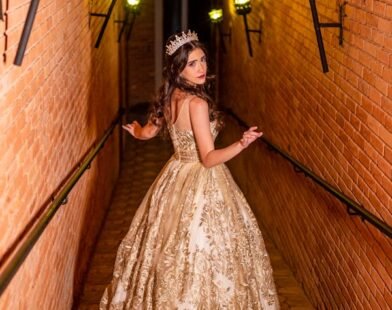 A WOMAN PASSING THROUGH A PASSAGE WHERE RECESSED LIGHTING CASING GLOWING