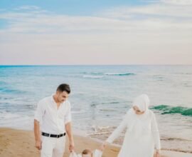 FATHER AND MOTHER ENJOYING SEA SITE WITH THEIR KID