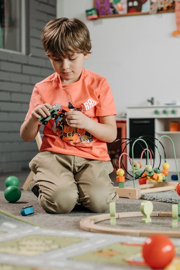 A YOUNG KID EXPERIMENTING WITH TOYS