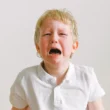 A YOUNG CUTE BOY CRYING SHOWING TODDLER TANTRUM