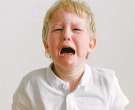 A YOUNG CUTE BOY CRYING SHOWING TODDLER TANTRUM