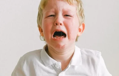 A YOUNG CUTE BOY CRYING SHOWING TODDLER TANTRUM