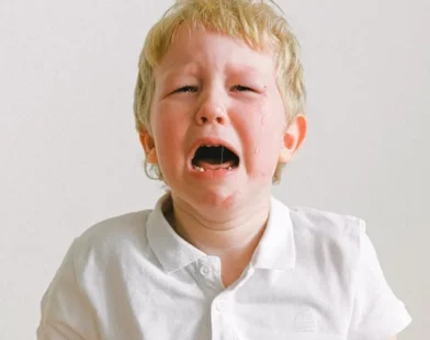 A YOUNG CUTE BOY CRYING SHOWING TODDLER TANTRUM